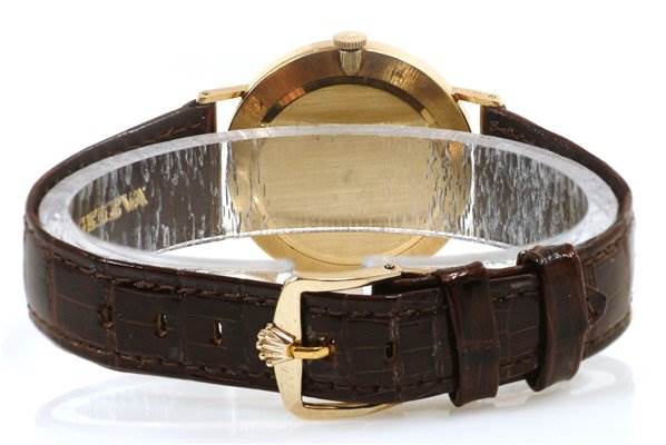 The image shows the rear view of a Rolex Cellini 3833 Men's Yellow Gold Champagne Dial 3833 Men's Yellow Gold Champagne Dial watch, highlighting the back case and leather strap with a buckle.