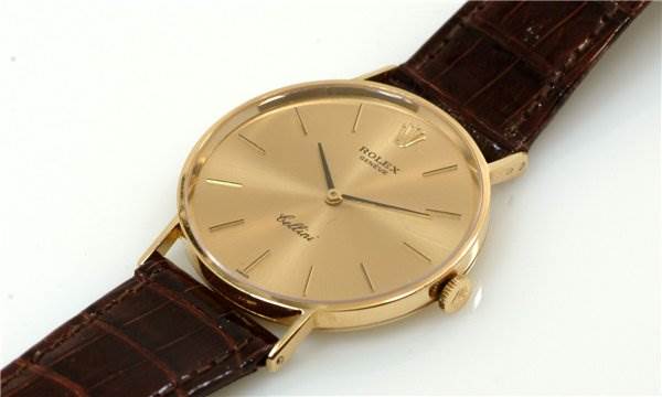 This Rolex Cellini 3833 Men's Yellow Gold Champagne Dial 3833 Men's Yellow Gold Champagne Dial watch is shown at a three-quarter angle displaying the dial, crown, and leather strap.