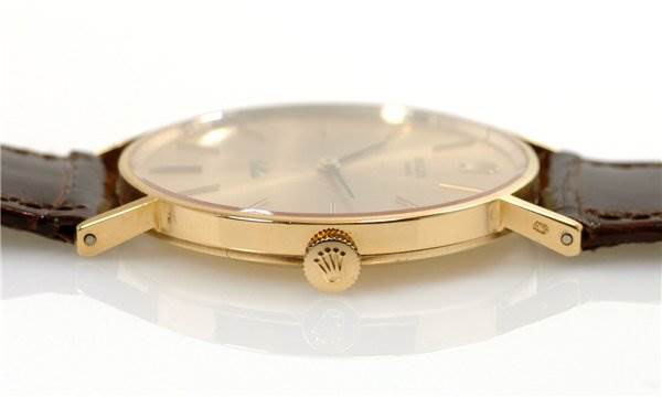 Side view of the Rolex Cellini 3833 Men's Yellow Gold Champagne Dial 3833 Men's Yellow Gold Champagne Dial model showing its crown and lugs with a leather strap attached.