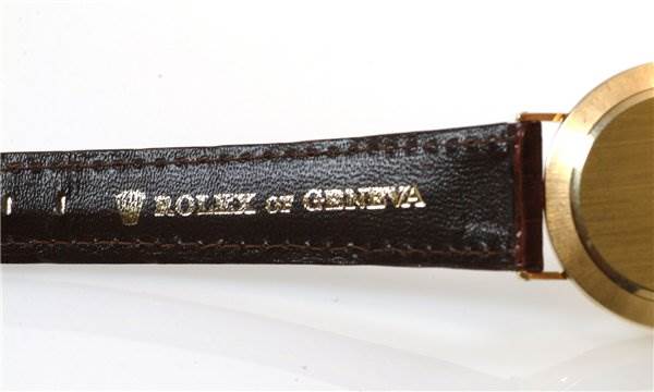 The image shows a close-up of the leather strap and part of the case back of a Rolex Cellini 3833 Men's Yellow Gold Champagne Dial 3833 Men's Yellow Gold Champagne Dial watch.