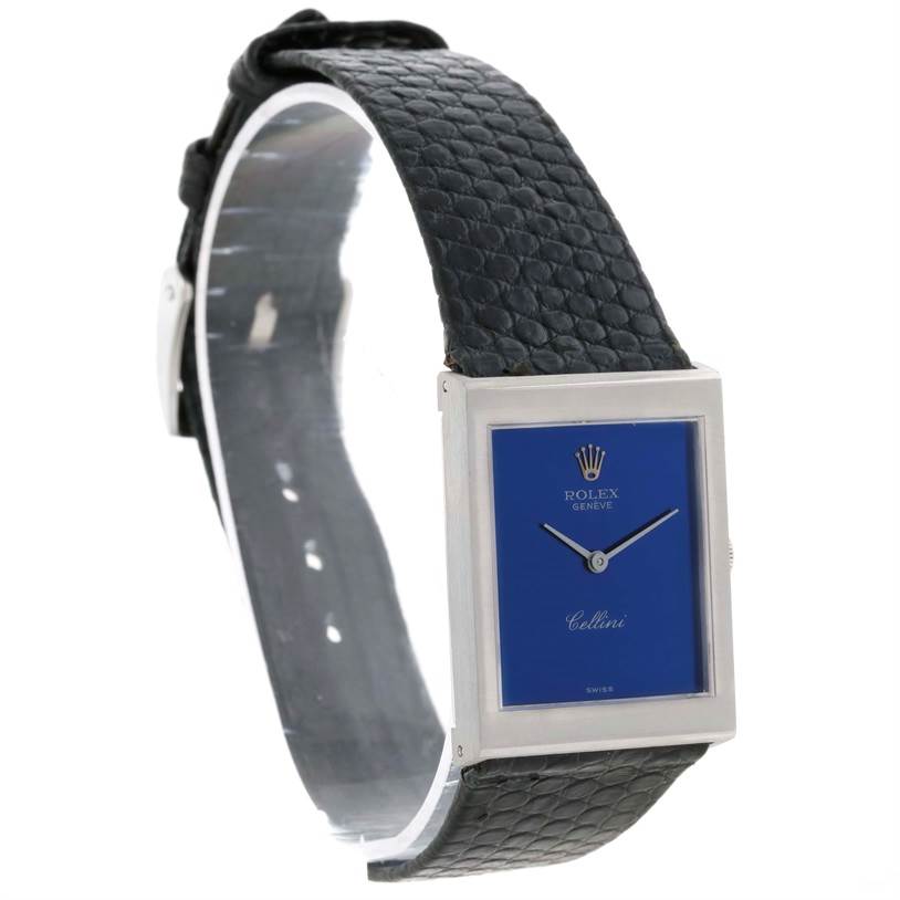 The image shows a Rolex Cellini 4014 Men's White Gold Blue Dial 4014 Men's White Gold Blue Dial watch at a slight angle, highlighting its blue dial, rectangular case, and black leather strap.