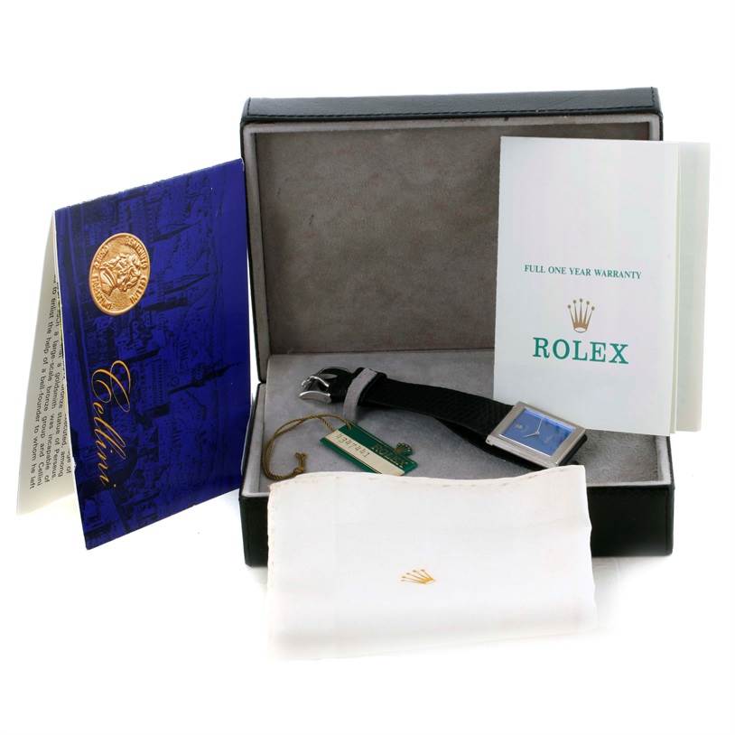 The image shows a Rolex Cellini 4014 Men's White Gold Blue Dial 4014 Men's White Gold Blue Dial watch in its open box, alongside warranty booklets and a cleaning cloth.