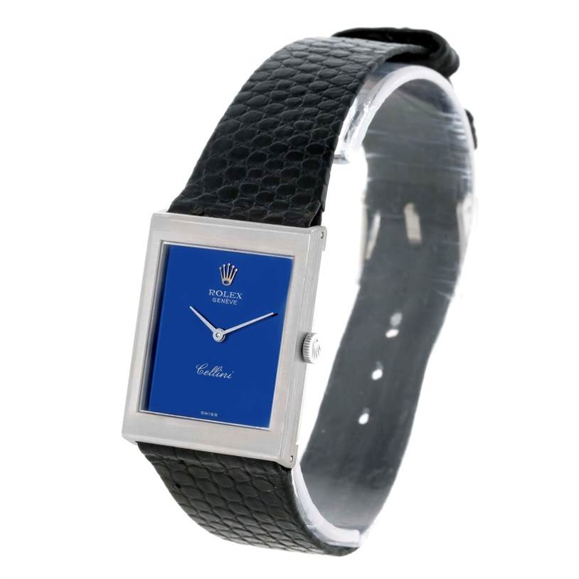 The image shows a Rolex Cellini 4014 Men's White Gold Blue Dial 4014 Men's White Gold Blue Dial watch at a three-quarter angle, highlighting its blue dial, rectangular case, and black leather strap.