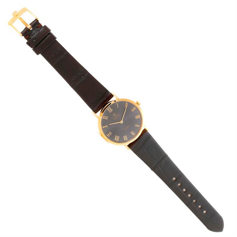 The Rolex Cellini 4112 Men
s Yellow Gold Grey Dial 4112 Men
s Yellow Gold Grey Dial watch is shown in a flat lay angle displaying the full strap, dial, and buckle.