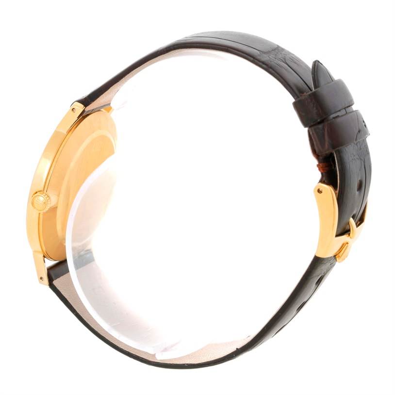 The image shows a side view of the Rolex Cellini 4112 Men
s Yellow Gold Grey Dial 4112 Men
s Yellow Gold Grey Dial watch, highlighting the gold case, crown, and the leather strap with its buckle.