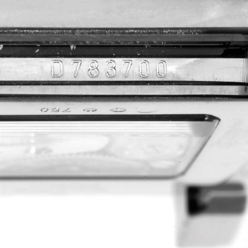 The image shows a close-up of the side of a Rolex Cellini 5443 Men's White Gold Black Dial 5443 Men's White Gold Black Dial watch, focusing on its serial number engraved on the case.