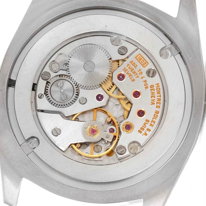 The image shows a close-up, internal view of a Rolex Cellini 4233 Men
s White Gold White Dial 4233 Men
s White Gold White Dial model watch
s movement and mechanical parts.