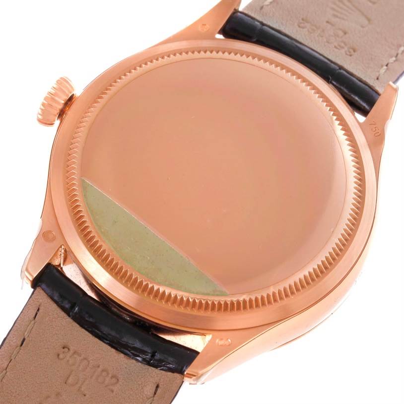 This image shows the back case and part of the strap of the Rolex Cellini 50525 Men's Rose Gold Black Dial 50525 Men's Rose Gold Black Dial watch from a close-up angle.