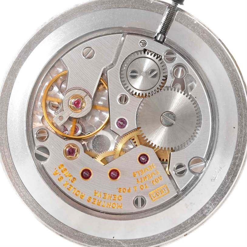 The image shows a close-up view of the movement mechanism inside a Rolex Cellini 5112 Men's Yellow Gold Beige Dial 5112 Men's Yellow Gold Beige Dial watch, highlighting gears and intricate components.