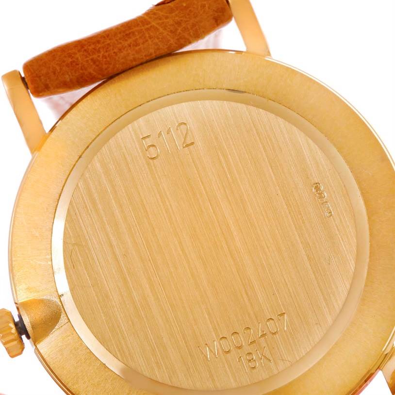 The image shows the back of a Rolex Cellini 5112 Men's Yellow Gold Beige Dial 5112 Men's Yellow Gold Beige Dial watch, highlighting its serial number and 18K gold casing.