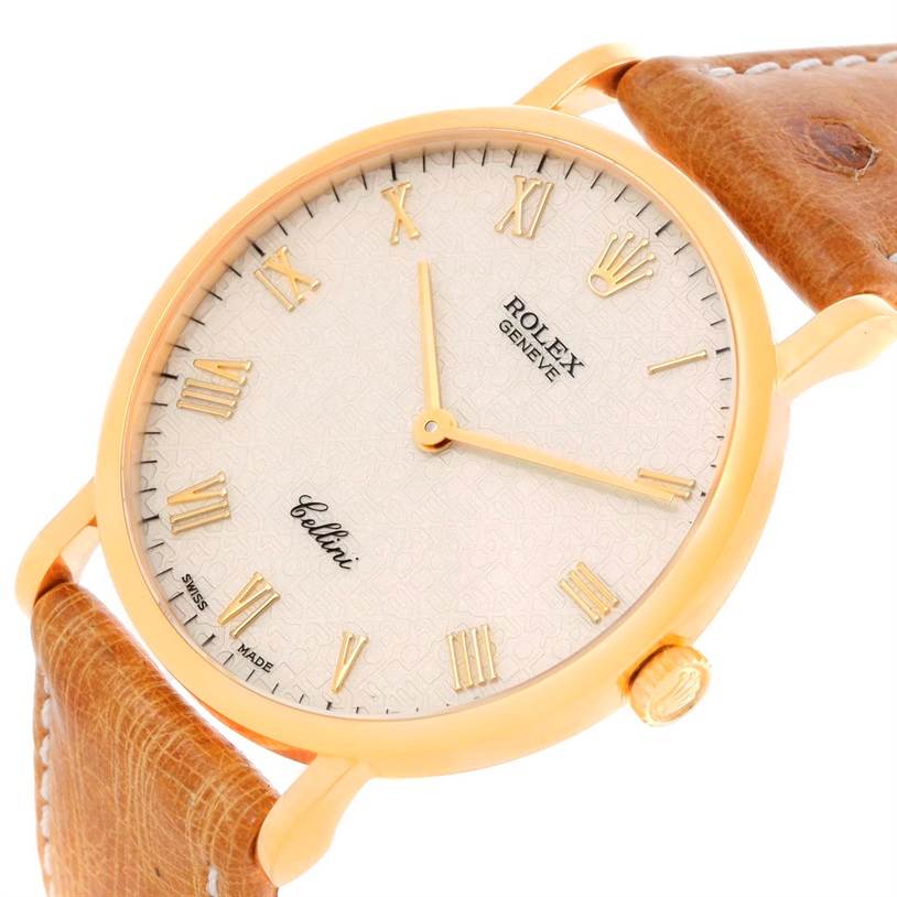 The image shows a close-up angled view of the Rolex Cellini 5112 Men's Yellow Gold Beige Dial 5112 Men's Yellow Gold Beige Dial watch dial, case, and part of the leather strap.