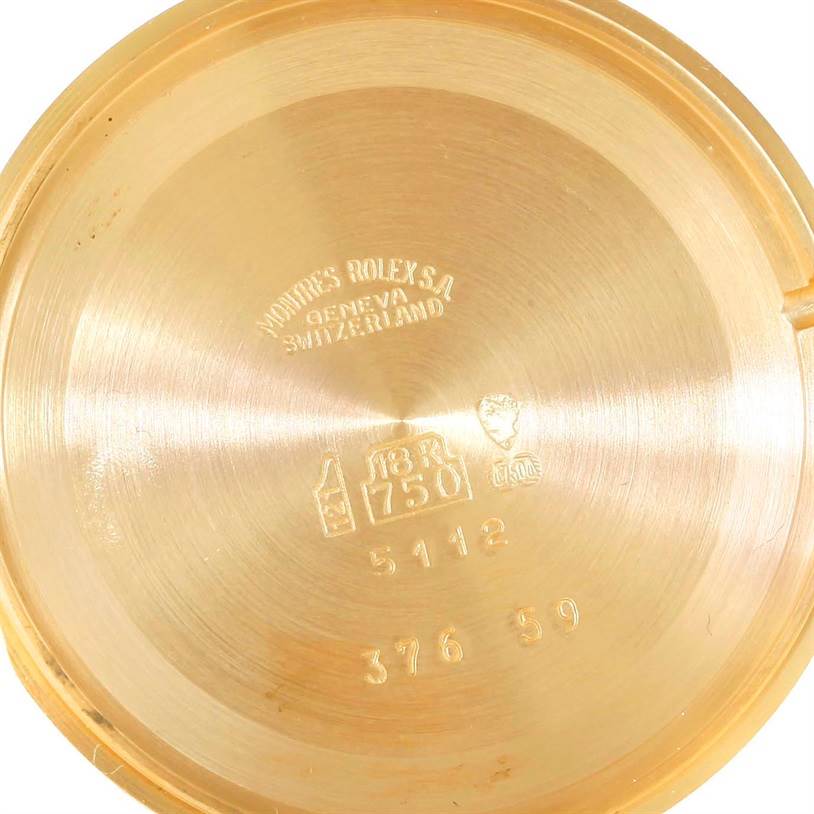 This image shows the inside of the case back of a Rolex Cellini 5112 Men's Yellow Gold Beige Dial 5112 Men's Yellow Gold Beige Dial watch, displaying engravings and hallmarks.