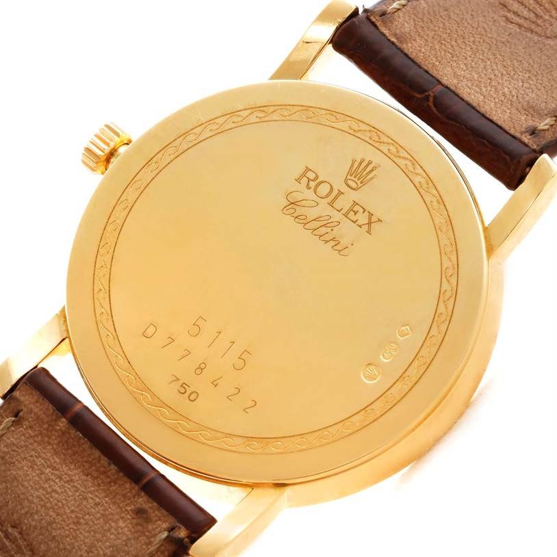 The image shows the back case of a Rolex Cellini 5115 Men
s Yellow Gold Champagne Dial 5115 Men
s Yellow Gold Champagne Dial watch, highlighting the engraved model information and strap attachments.
