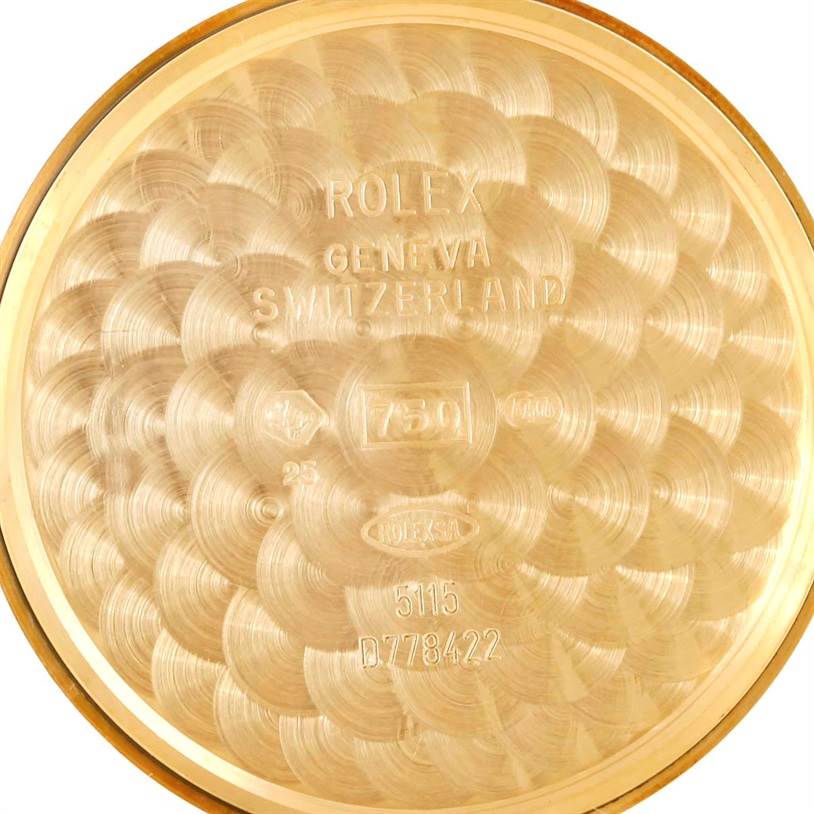 The image shows an interior view of the back case of a Rolex Cellini 5115 Men
s Yellow Gold Champagne Dial 5115 Men
s Yellow Gold Champagne Dial watch, with engraved markings and textured patterns.