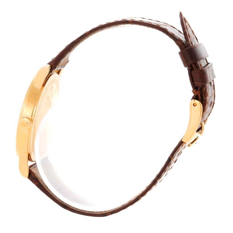 The image shows a side view of a Rolex Cellini 5115 Men
s Yellow Gold Champagne Dial 5115 Men
s Yellow Gold Champagne Dial watch, highlighting the gold case, side crown, and brown leather strap.