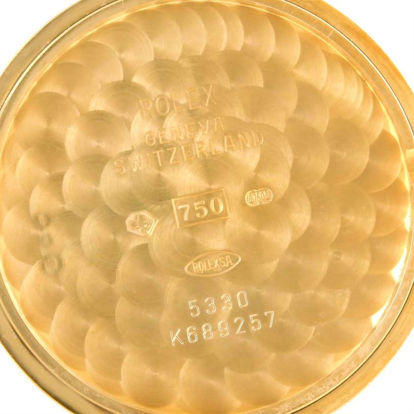 This image shows the inner case back of a Rolex Cellini 5330 Men's Yellow Gold White Dial 5330 Men's Yellow Gold White Dial model watch, featuring the embossed markings and gold texture.