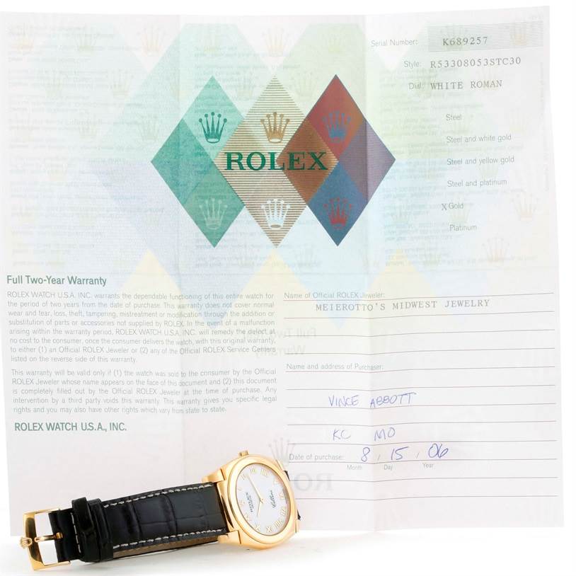 The image shows a Cellini model by Rolex watch lying flat with the face and strap partially visible, alongside warranty documents.