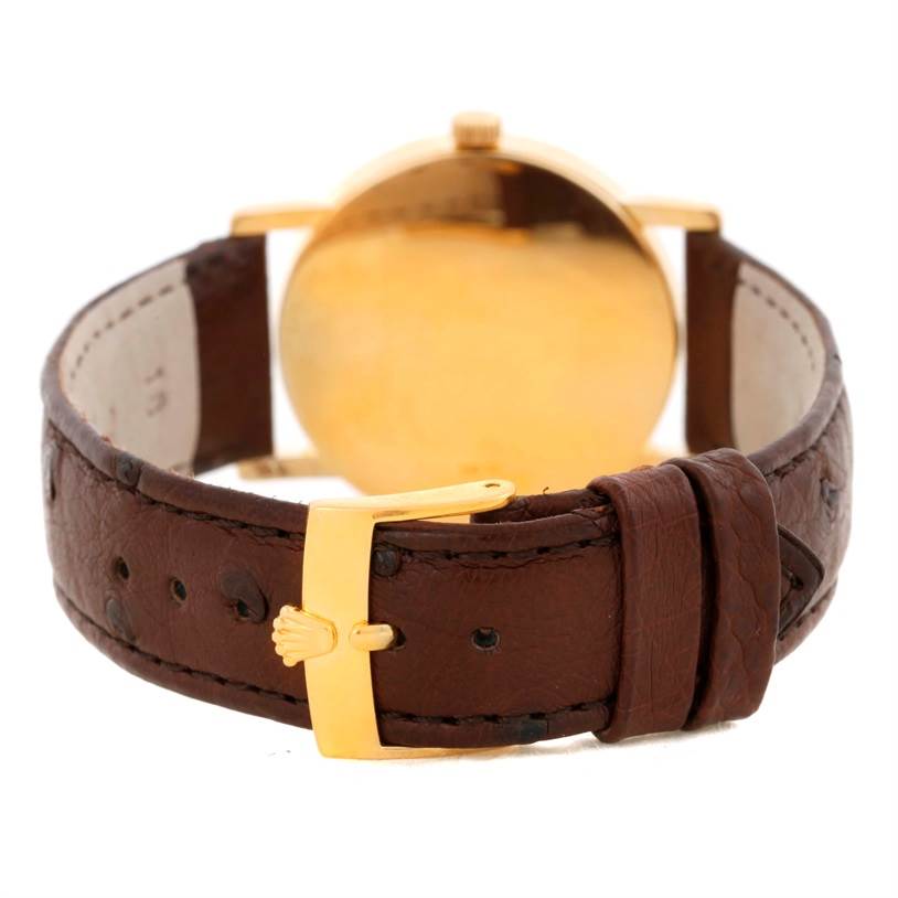 This image shows the back angle of a Rolex Cellini 5115 Men
s Yellow Gold Silver Dial 5115 Men
s Yellow Gold Silver Dial watch, focusing on the leather strap and gold buckle.