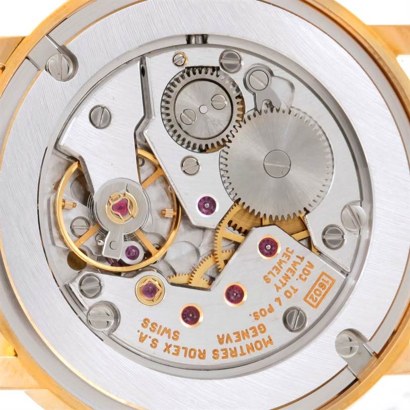 The image shows a close-up of the movement and internal components of a Rolex Cellini 5115 Men
s Yellow Gold Silver Dial 5115 Men
s Yellow Gold Silver Dial watch, viewed from the back.