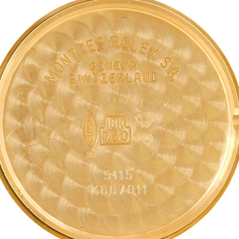 This is a close-up image of the inside case back of a Rolex Cellini 5115 Men
s Yellow Gold Beige Dial 5115 Men
s Yellow Gold Beige Dial watch, revealing details like the model number and 18K gold marking.