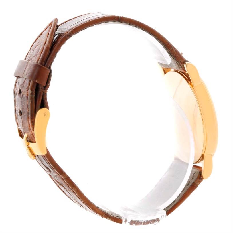 The image shows a side profile of a Rolex Cellini 5115 Men
s Yellow Gold Beige Dial 5115 Men
s Yellow Gold Beige Dial watch featuring a brown leather strap and a gold case.