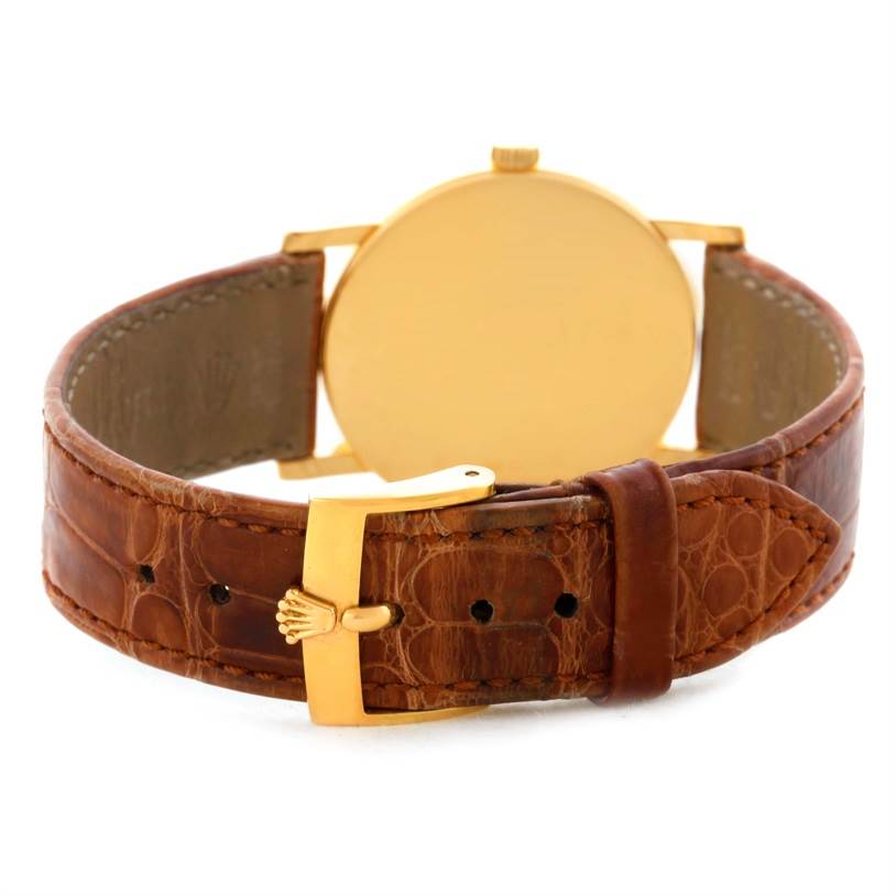 The image shows the back view of a Rolex Cellini 5115 Men
s Yellow Gold Beige Dial 5115 Men
s Yellow Gold Beige Dial watch, highlighting the brown leather strap and gold buckle.