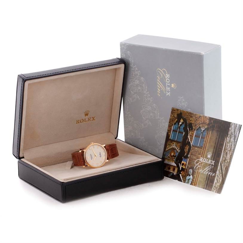 The image shows a Rolex Cellini 5115 Men
s Yellow Gold Beige Dial 5115 Men
s Yellow Gold Beige Dial watch inside an open box, along with an outer box and a booklet.