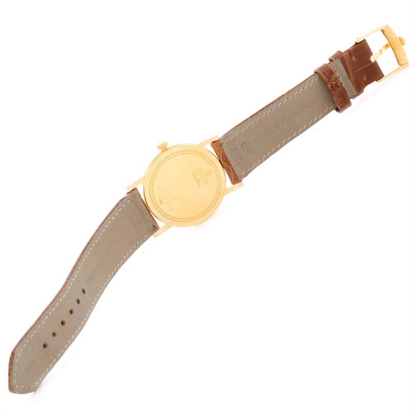 The image shows the back side and strap of a Rolex Cellini 5115 Men
s Yellow Gold Champagne Dial 5115 Men
s Yellow Gold Champagne Dial watch laid flat.