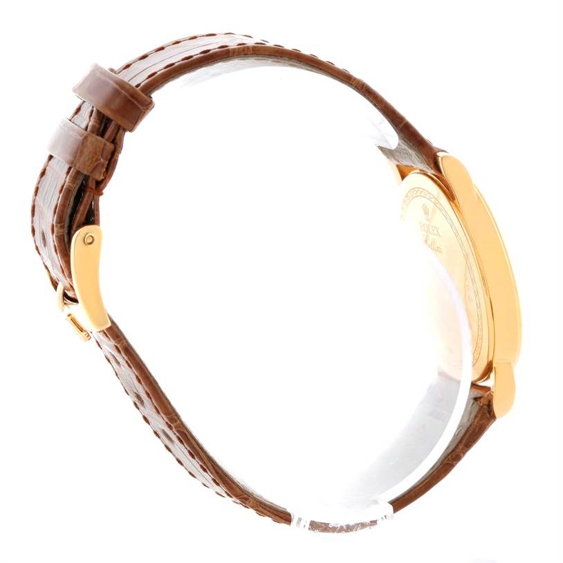 This image shows a side view of a Rolex Cellini 5115 Men
s Yellow Gold Champagne Dial 5115 Men
s Yellow Gold Champagne Dial watch, displaying its leather strap and gold case.
