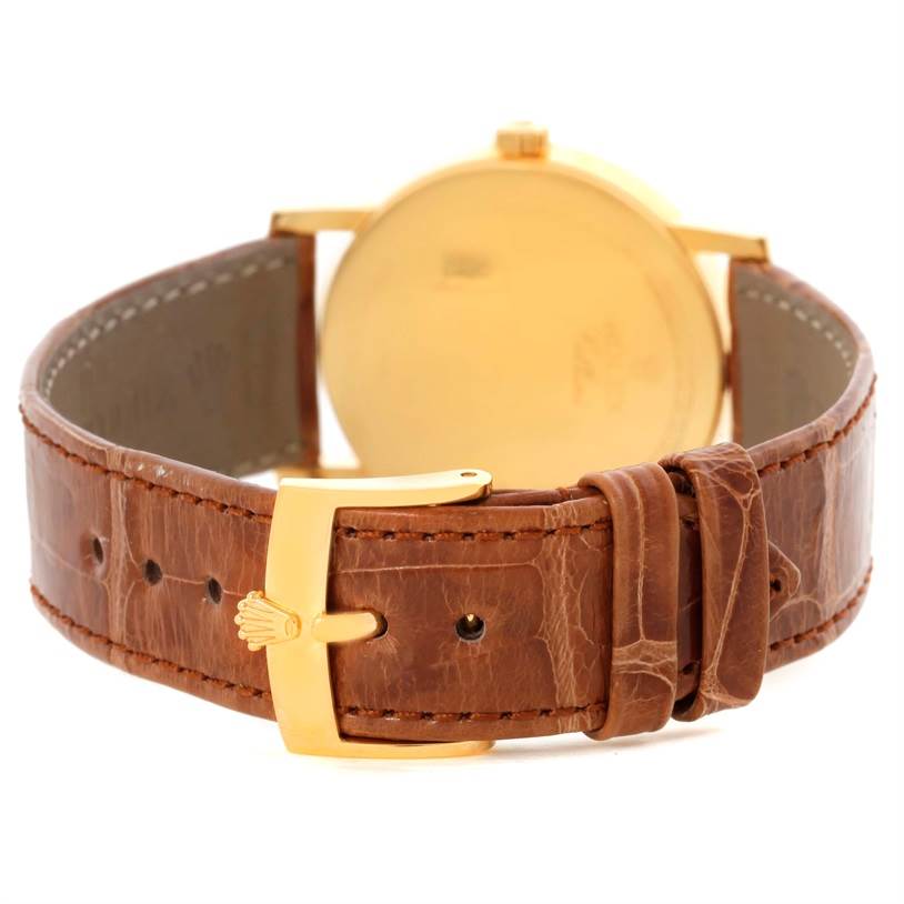 The image shows the back view of a Rolex Cellini 5115 Men
s Yellow Gold Mother of Pearl Dial 5115 Men
s Yellow Gold Mother of Pearl Dial watch, focusing on the brown leather strap and gold clasp.