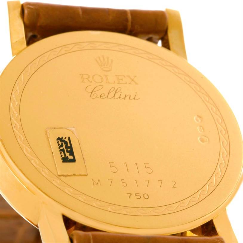 The image shows the back of a Rolex Cellini 5115 Men
s Yellow Gold Mother of Pearl Dial 5115 Men
s Yellow Gold Mother of Pearl Dial watch, highlighting the case back with engraved details and part of the leather strap.