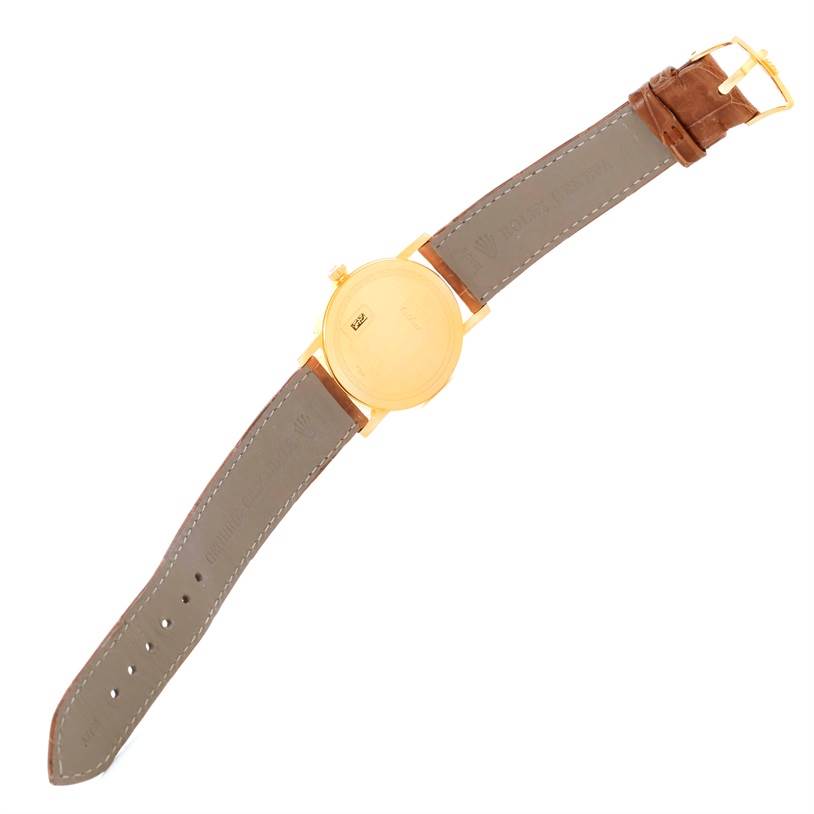 The image shows the back view of a Rolex Cellini 5115 Men
s Yellow Gold Mother of Pearl Dial 5115 Men
s Yellow Gold Mother of Pearl Dial watch with a leather strap fully extended.