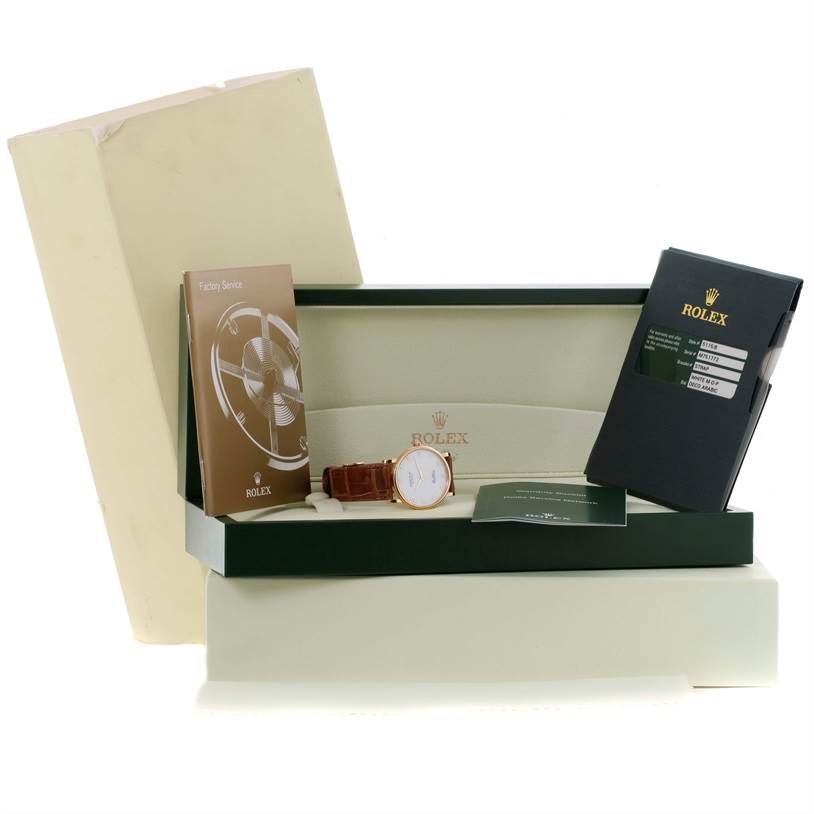 This image shows the Rolex Cellini 5115 Men
s Yellow Gold Mother of Pearl Dial 5115 Men
s Yellow Gold Mother of Pearl Dial watch with its box, service booklet, warranty card, and other documentation.