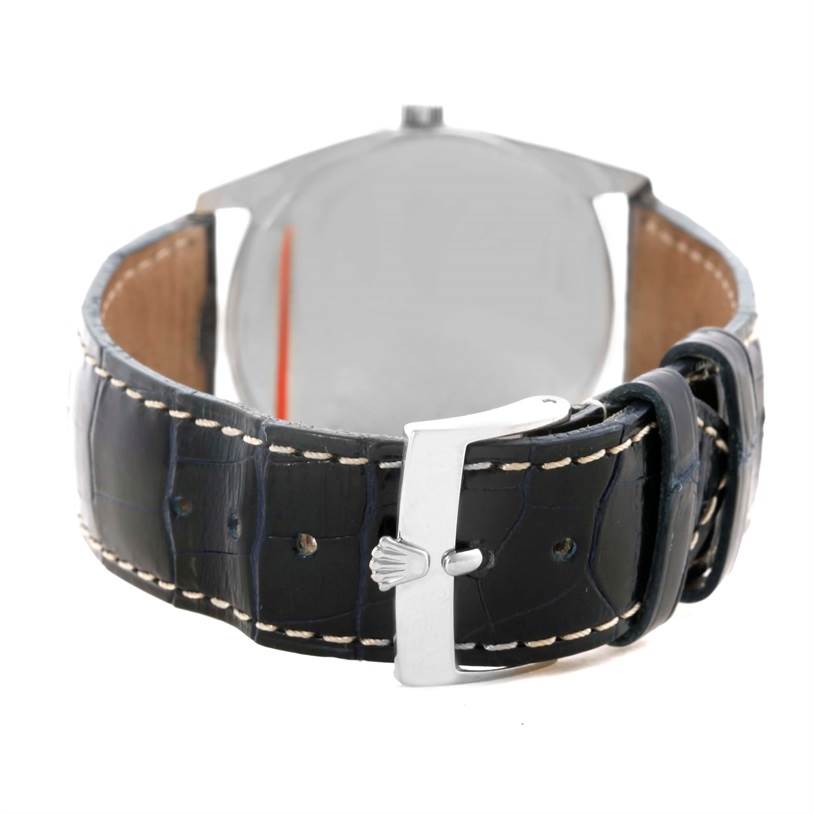 The image shows the back view of the Rolex Cellini 4233 Men
s White Gold White Dial 4233 Men
s White Gold White Dial watch, highlighting its leather strap and clasp.