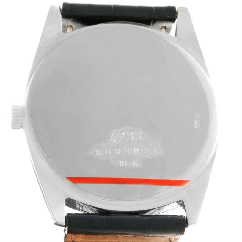 This image shows the back case of a Rolex Cellini 4233 Men
s White Gold White Dial 4233 Men
s White Gold White Dial model watch, displaying engravings and part of the leather strap.