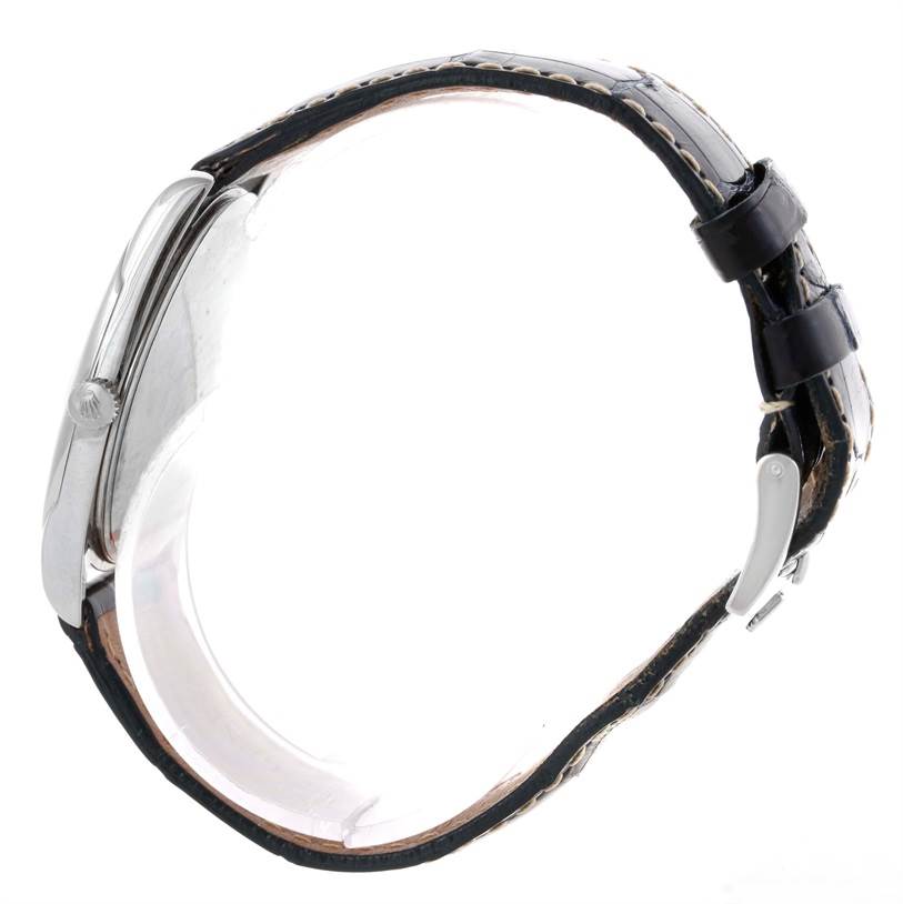 This side view of the Rolex Cellini 4233 Men
s White Gold White Dial 4233 Men
s White Gold White Dial watch shows its case, crown, and black leather strap with clasps.