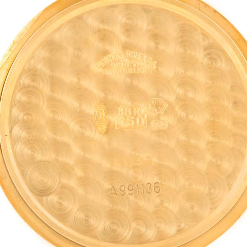 This image shows the inner case back of a Rolex Cellini 4233 Men's Yellow Gold White Dial 4233 Men's Yellow Gold White Dial watch, highlighting its engravings and gold texture.