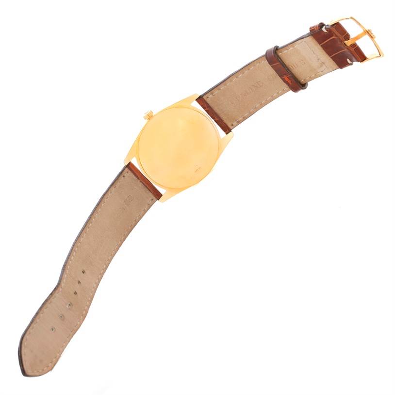 The Rolex Cellini 4233 Men's Yellow Gold White Dial 4233 Men's Yellow Gold White Dial watch is shown from the back, displaying its leather strap and gold case.