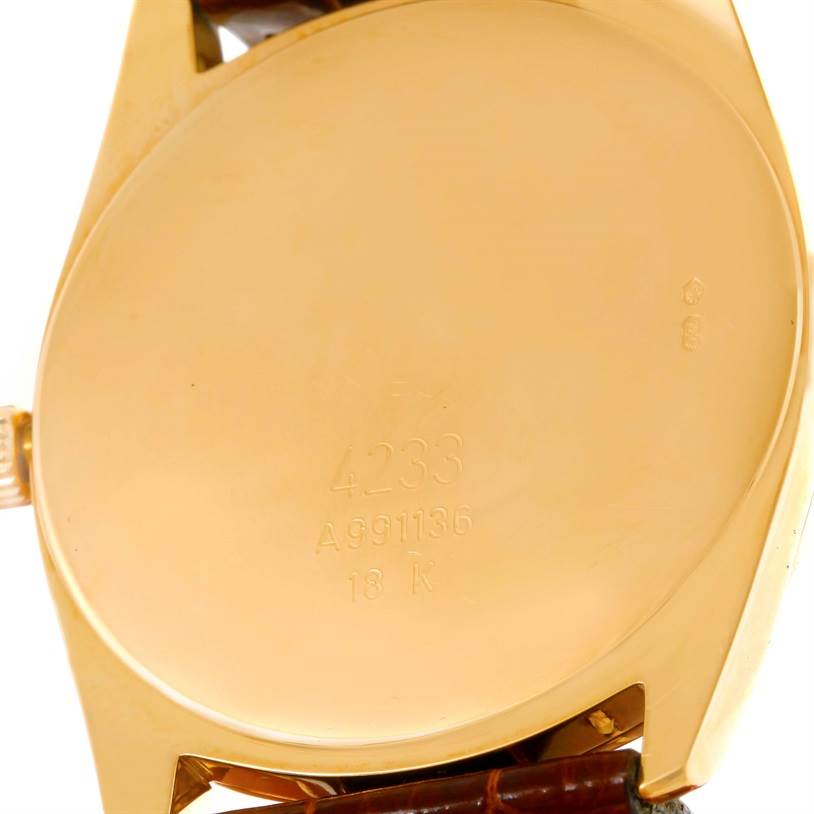 The image shows the back case of a Rolex Cellini 4233 Men's Yellow Gold White Dial 4233 Men's Yellow Gold White Dial watch, highlighting its gold finish and engravings.
