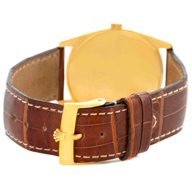 The image shows the back of the Rolex Cellini 4233 Men's Yellow Gold White Dial 4233 Men's Yellow Gold White Dial watch, highlighting its leather strap and gold clasp.