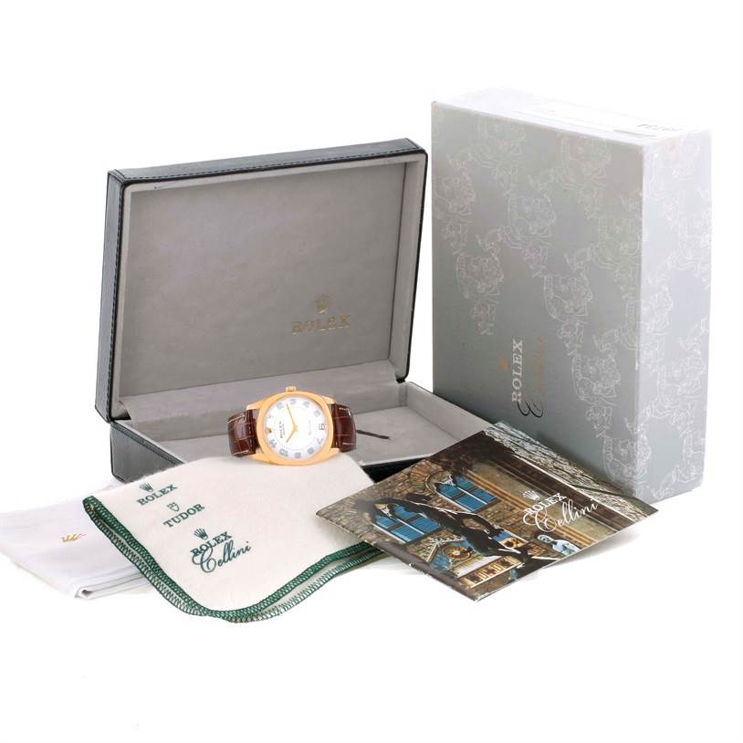 This image shows a Rolex Cellini 4233 Men's Yellow Gold White Dial 4233 Men's Yellow Gold White Dial model watch in its open box, accompanied by documentation and cleaning cloths.