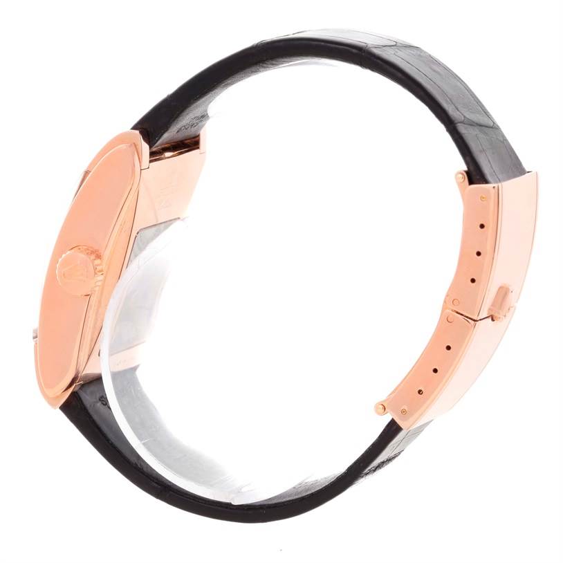 This image showcases a side view of the Rolex Cellini 5442.5 Men's Rose Gold Black Dial 5442.5 Men's Rose Gold Black Dial watch, highlighting the crown, case, and a portion of the leather strap.