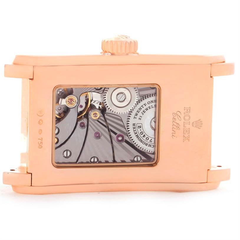 This image shows the back view of a Rolex Cellini 5442.5 Men's Rose Gold Black Dial 5442.5 Men's Rose Gold Black Dial watch, displaying its inner mechanical movements and gears.