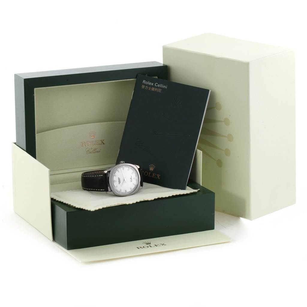 The image shows a Rolex Cellini 4243 Men's White Gold White Dial 4243 Men's White Gold White Dial watch inside its opened green and cream box, accompanied by the manual.
