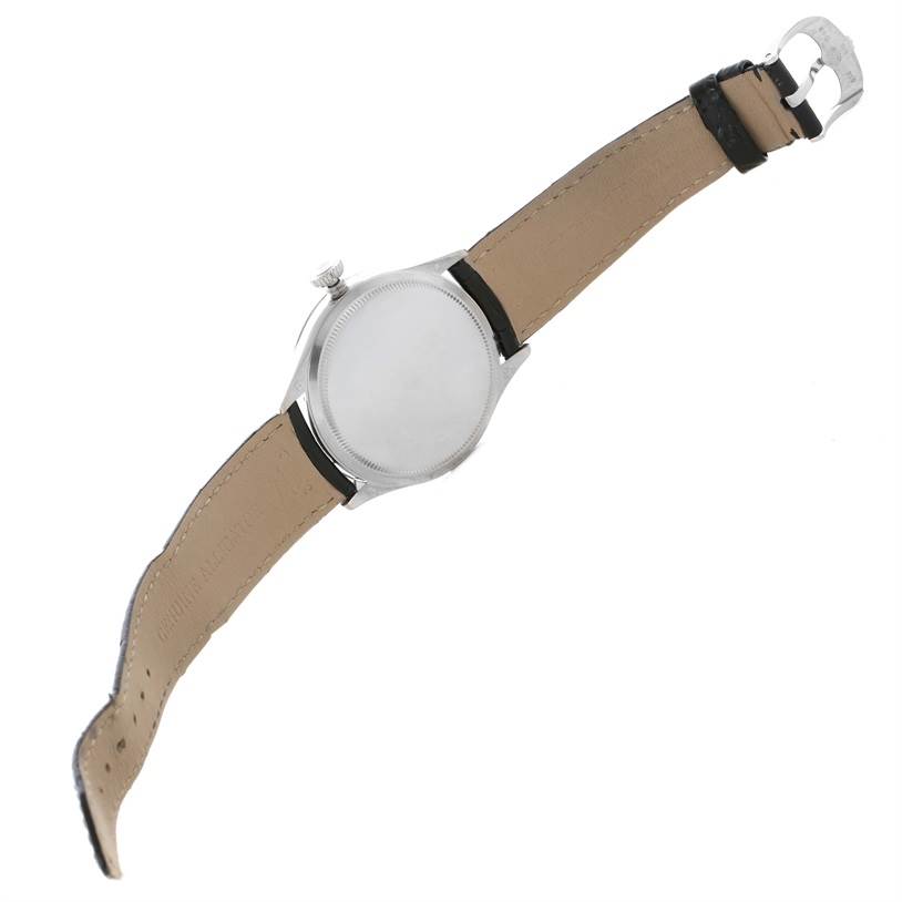 This Rolex Cellini 50509 Men's White Gold White Dial 50509 Men's White Gold White Dial watch is shown from the back, highlighting its case, crown, and leather strap with a buckle.