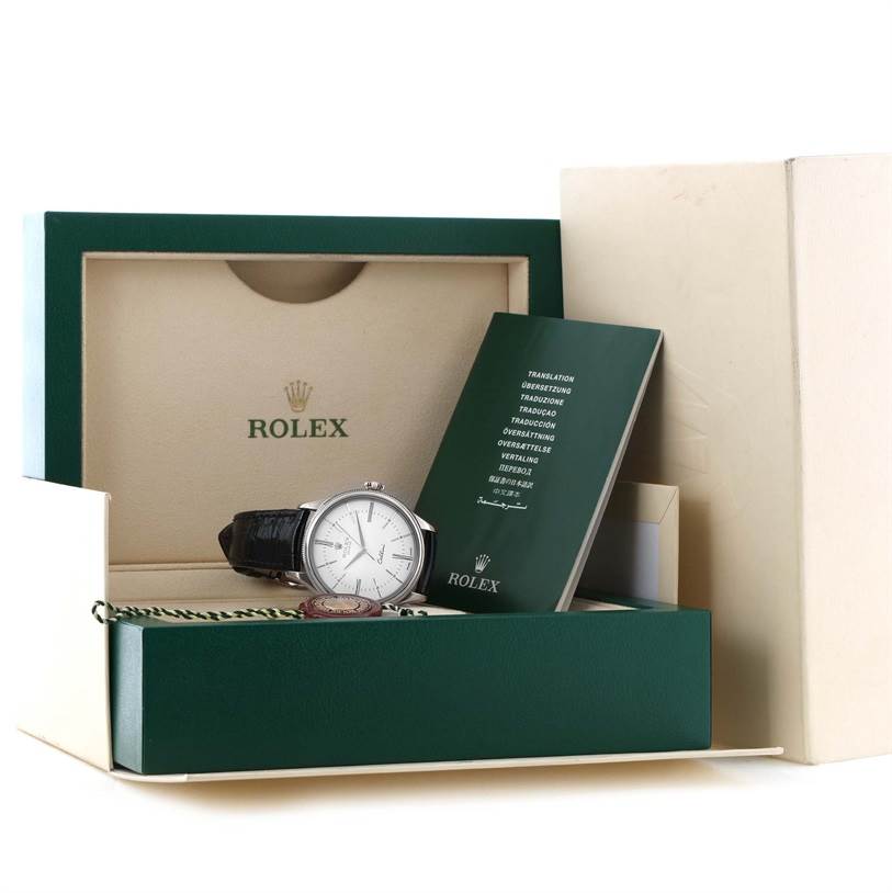 The image shows a Rolex Cellini 50509 Men's White Gold White Dial 50509 Men's White Gold White Dial watch, its box, and accompanying booklet from a front facing angle.