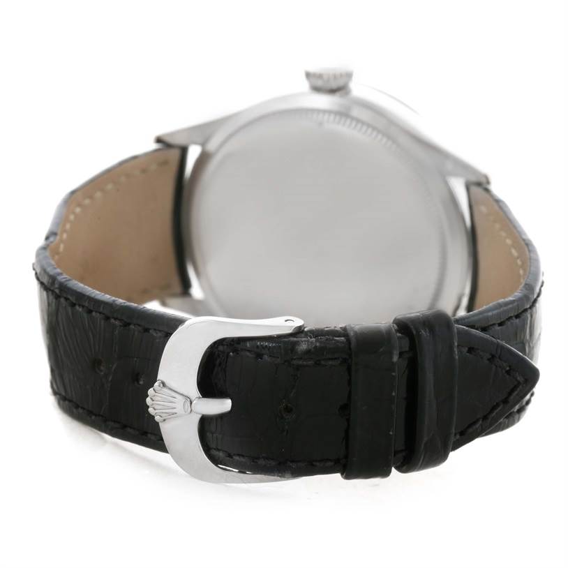 This image shows the rear view of a Rolex Cellini 50509 Men's White Gold White Dial 50509 Men's White Gold White Dial watch, focusing on its black leather strap and clasp with the Rolex crown logo.