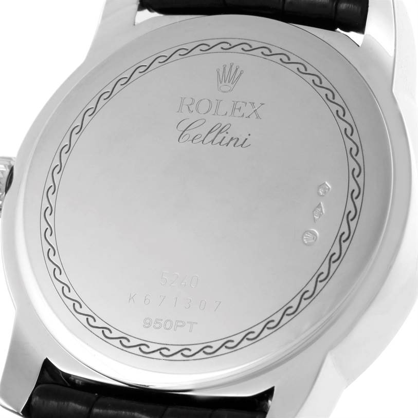 The image shows the back case of a Rolex Cellini 5240 Men
s Platinum Mother of Pearl Dial 5240 Men
s Platinum Mother of Pearl Dial watch, featuring engraved details and part of the strap.
