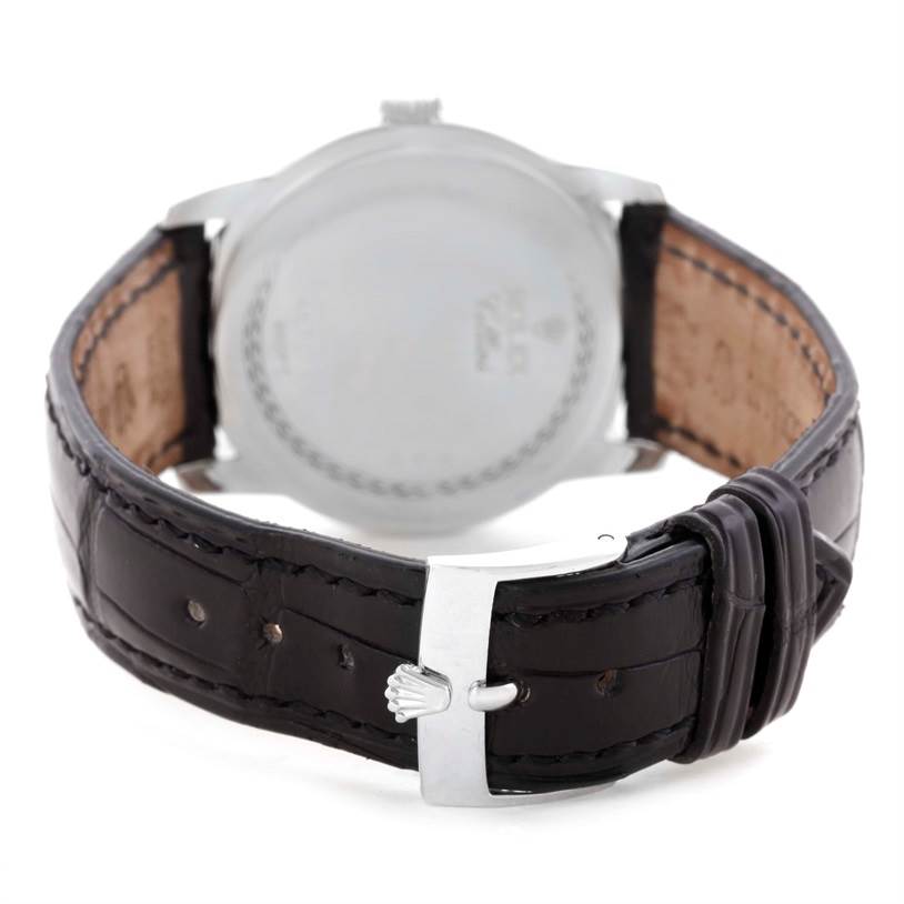 This image shows the back of a Rolex Cellini 5240 Men
s Platinum Mother of Pearl Dial 5240 Men
s Platinum Mother of Pearl Dial watch and its leather strap with a branded buckle.