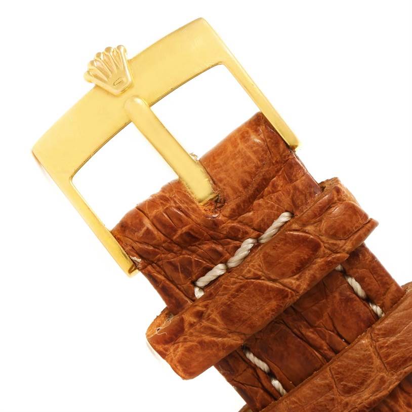 This image shows the gold buckle and brown leather strap of a Rolex Cellini 5116 Yellow Gold Grey Dial 5116 Yellow Gold Grey Dial watch.